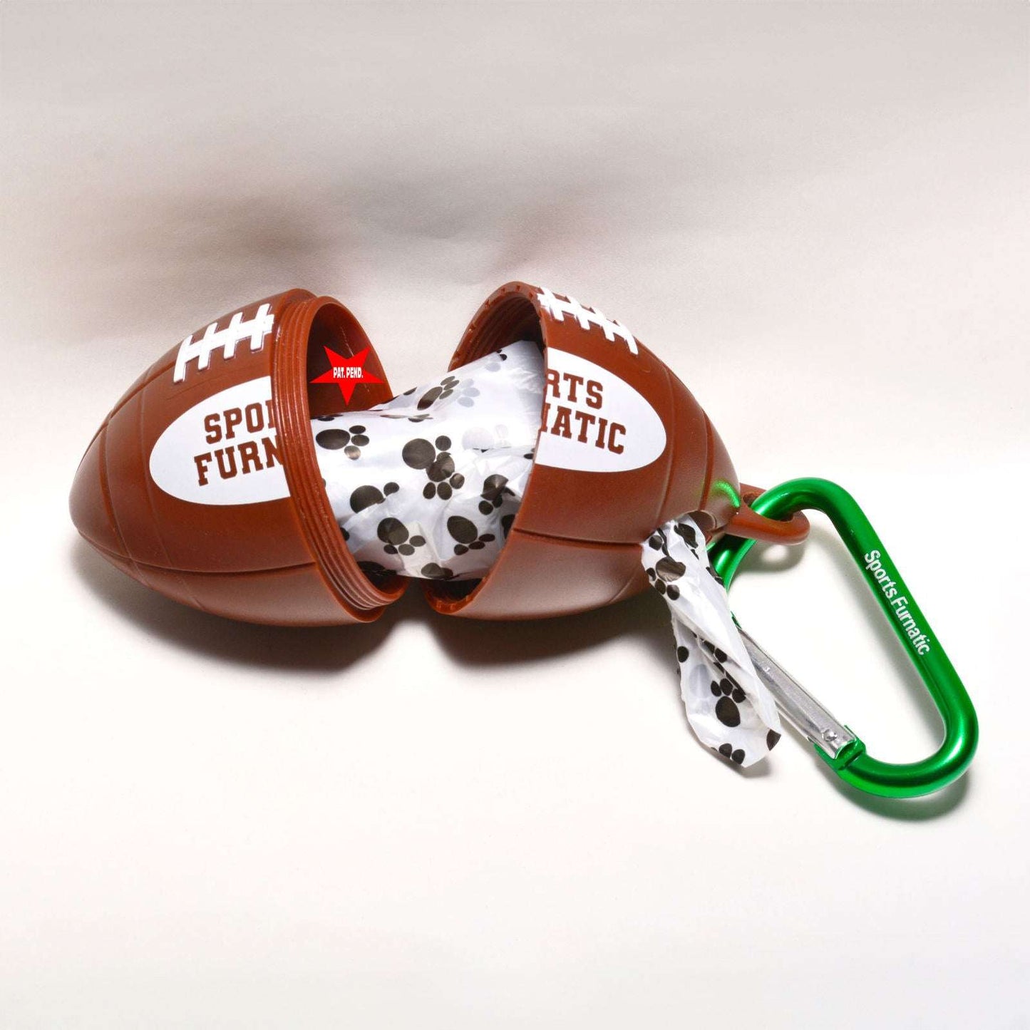 Sports Furnatic's poop bag dispenser named The Tail Gater®. This one is unscrewed so you can see the roll inside, and where the bag is pulled out of the hole. This unit is customized with a Green carabiner and a White bag roll.