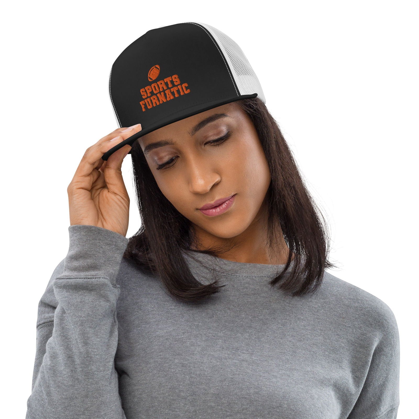 Sports Furnatic's Trucker Hat on female model, looking down, and right hand on the brim, with logo centered in front and Orange embroidery-Printful Product