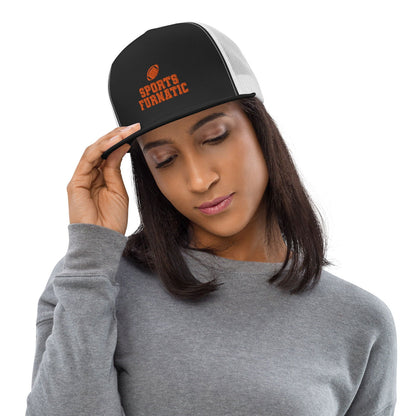 Sports Furnatic's Trucker Hat on female model, looking down, and right hand on the brim, with logo centered in front and Orange embroidery-Printful Product
